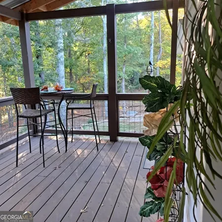 a living room filled with furniture and a potted plant