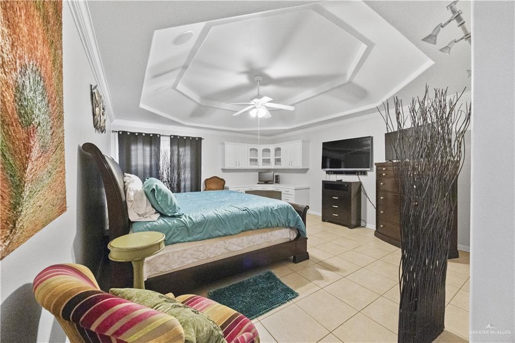 800 East Mile 3 Road Mission, TX 78573 - Photo 36 of 45 Bedroom featuring a raised ceiling, light tile patterned floors, a ceiling fan, and crown molding
