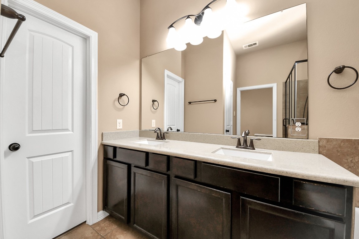 25122 Alina Lane Spring, TX 77386 - Photo 15 of 27 a bathroom with a double vanity sink and mirror