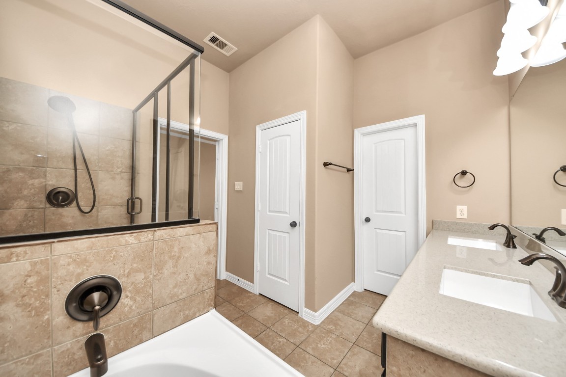 25122 Alina Lane Spring, TX 77386 - Photo 16 of 27 a bathroom with a tub and a sink