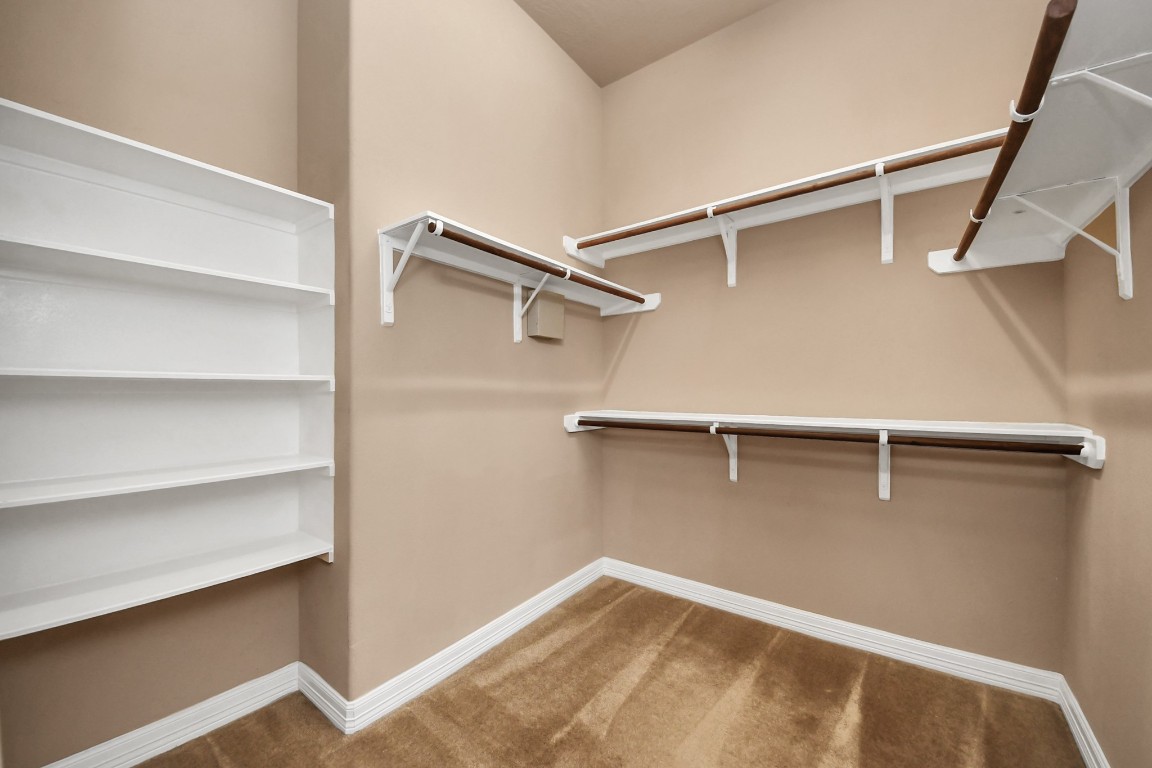 25122 Alina Lane Spring, TX 77386 - Photo 17 of 27 a view of walk in closet with empty racks