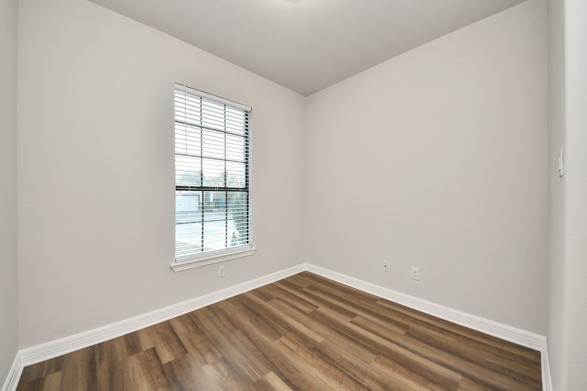 25122 Alina Lane Spring, TX 77386 - Photo 18 of 27 an empty room with wooden floor and windows