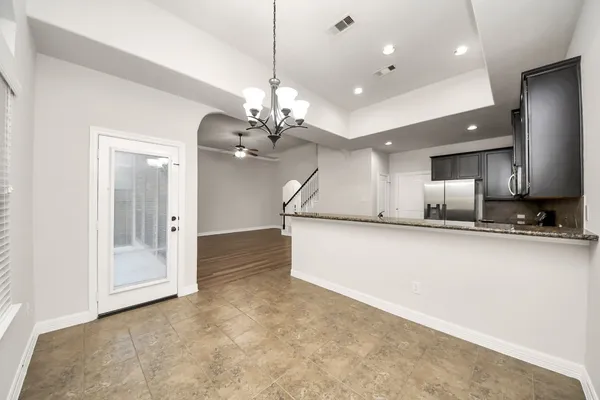 a view of a kitchen with a sink and a chandelier