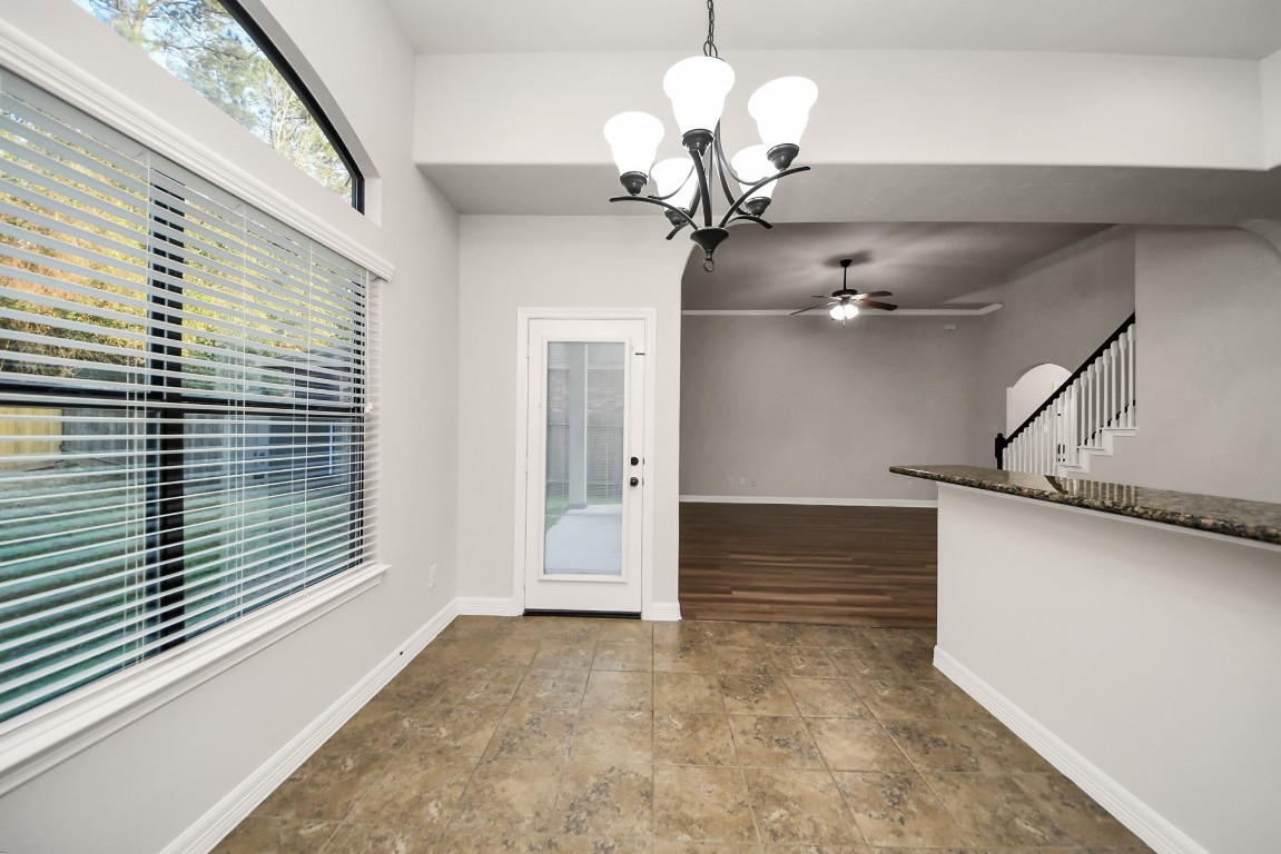25122 Alina Lane Spring, TX 77386 - Photo 7 of 27 a view of a chandelier fan and a large window