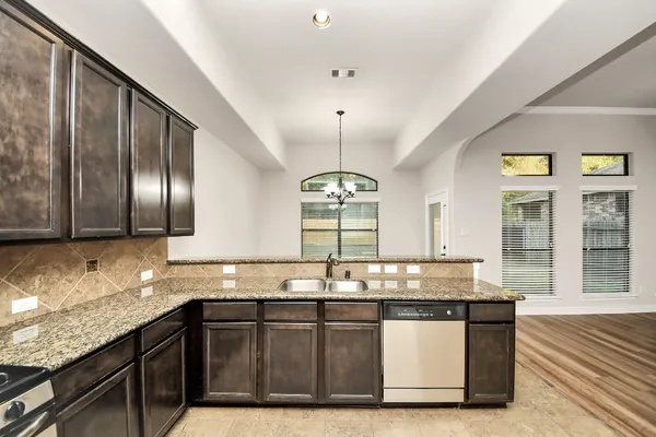 a kitchen with granite countertop a sink and a window