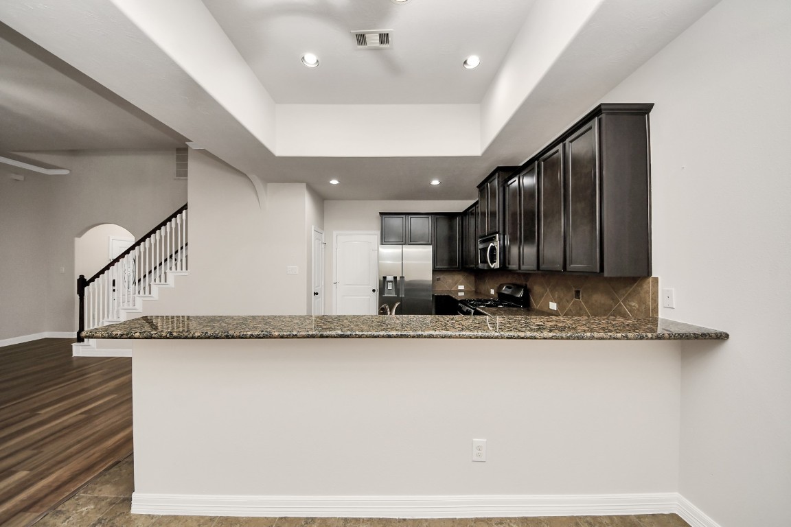 25122 Alina Lane Spring, TX 77386 - Photo 9 of 27 a view of a kitchen with kitchen island sink and faucet