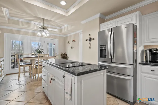 a kitchen with granite countertop a sink stove and cabinets