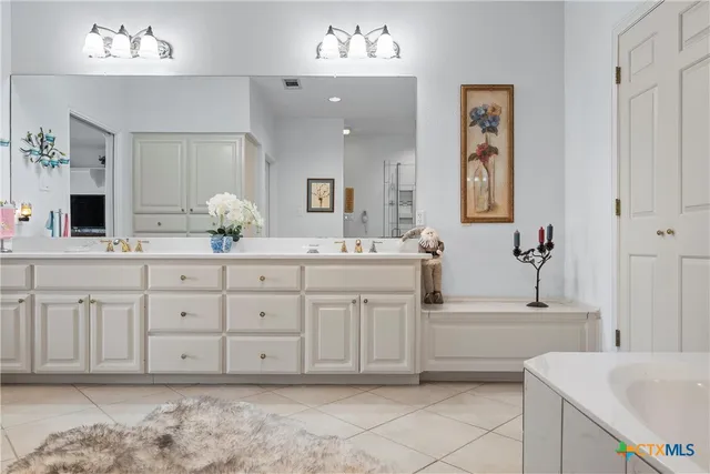 a bathroom with a shower sink and mirror