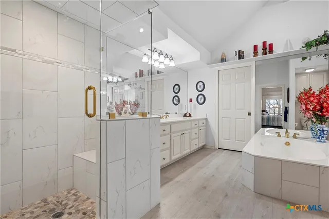 a spacious bedroom with a bed a table and chair