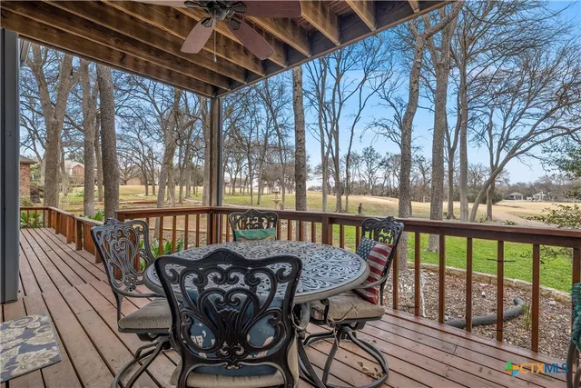 a view of balcony with wooden floor and outdoor seating