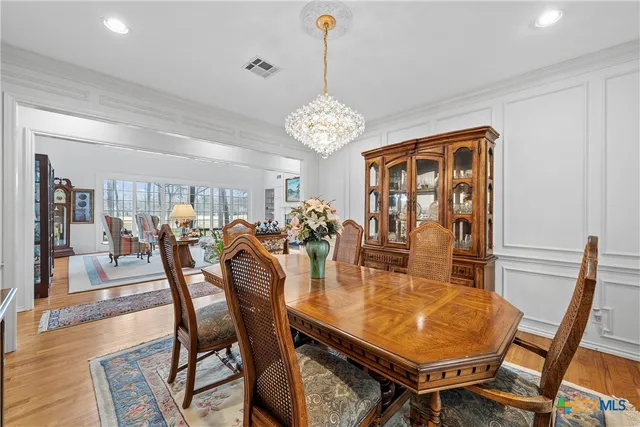 a living room with furniture a fireplace and a floor to ceiling window