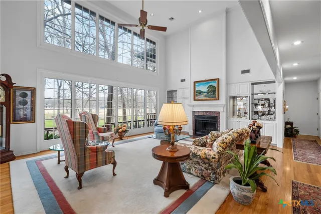 a dining room with furniture a chandelier and wooden floor