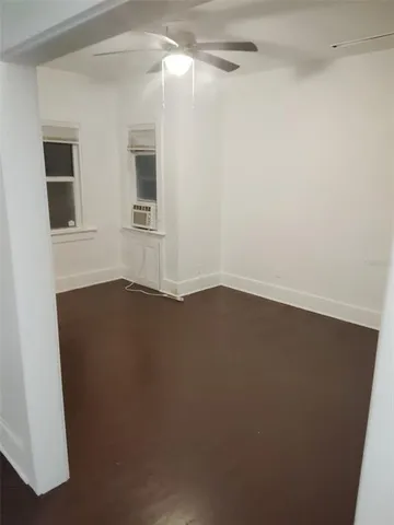 a view of small space with wooden floor and a window