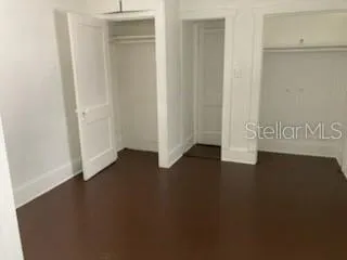 an empty room with wooden floor