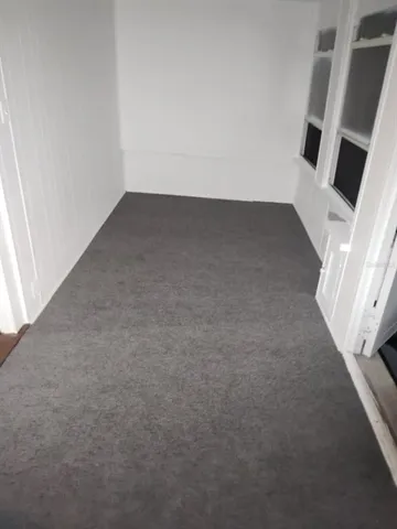 an empty room with a fireplace