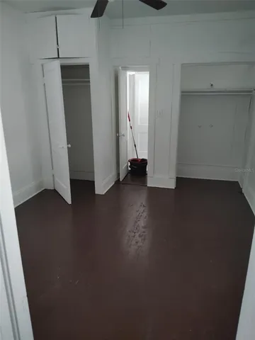 an empty room with wooden floor and closet