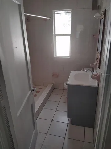 a bathroom with a sink toilet and window