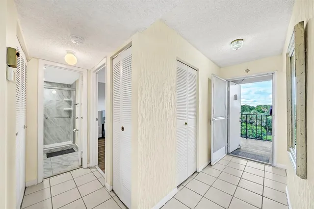 a view of a bathroom with shower and window