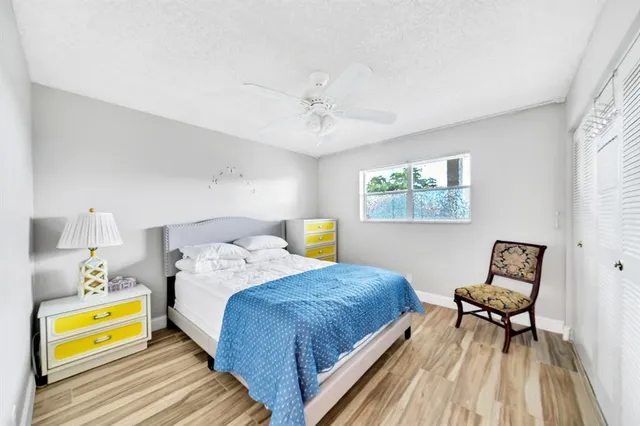 a bedroom with a bed and a lamp on dresser