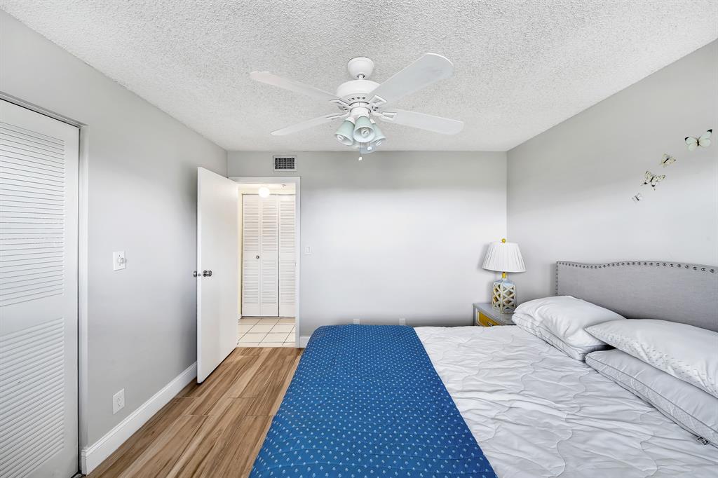6200 Northwest 44th Street, Unit 405 Lauderhill, FL 33319 - Photo 14 of 44 a bedroom with a bed and a chandelier
