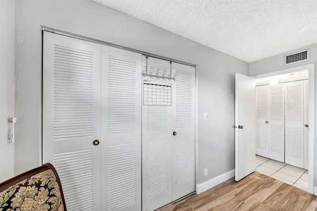 a view of a bathroom with wooden floor and a sink