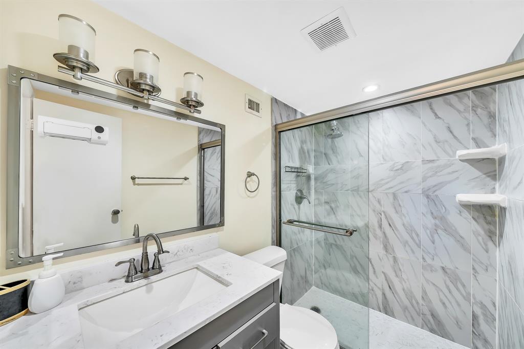 6200 Northwest 44th Street, Unit 405 Lauderhill, FL 33319 - Photo 17 of 44 a bathroom with a sink toilet a mirror and shower