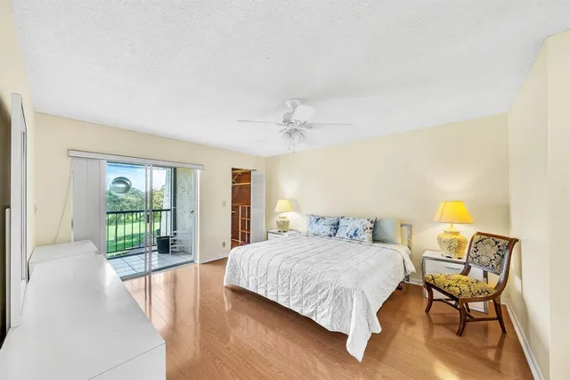 a living room with a bed furniture and a large window