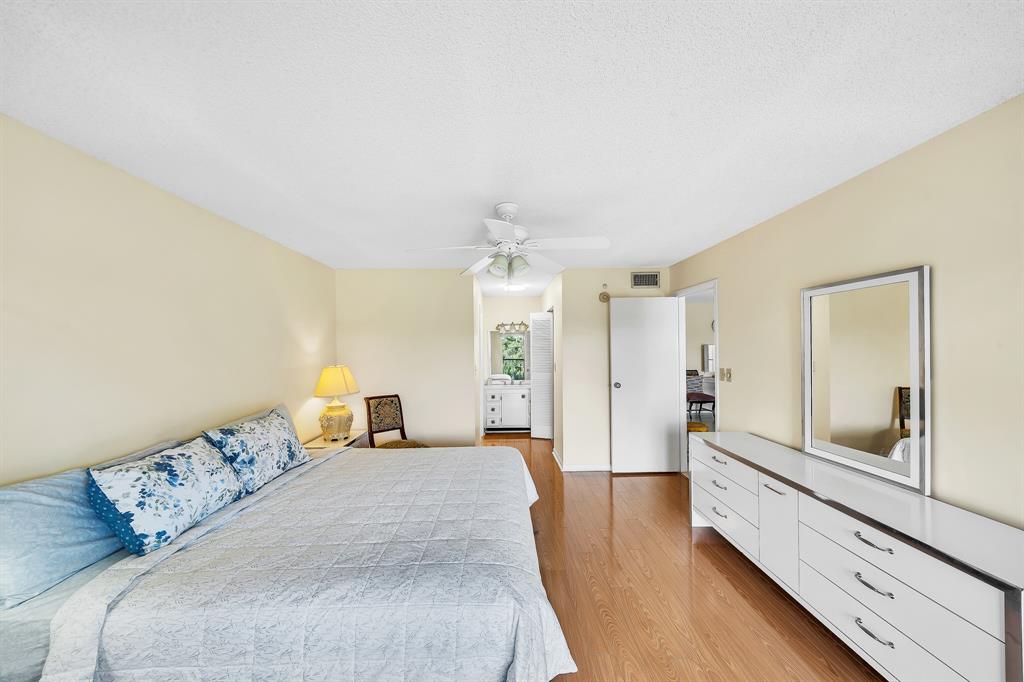 6200 Northwest 44th Street, Unit 405 Lauderhill, FL 33319 - Photo 27 of 44 a large bedroom with a bed and wooden floor
