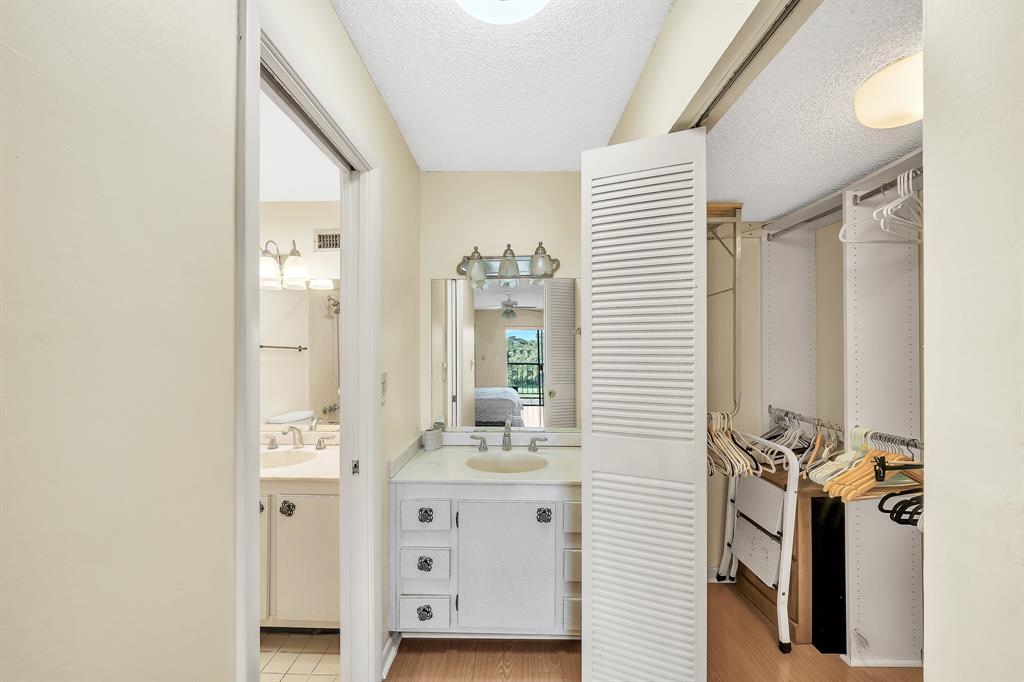 6200 Northwest 44th Street, Unit 405 Lauderhill, FL 33319 - Photo 28 of 44 a bathroom with a sink a mirror and a shower