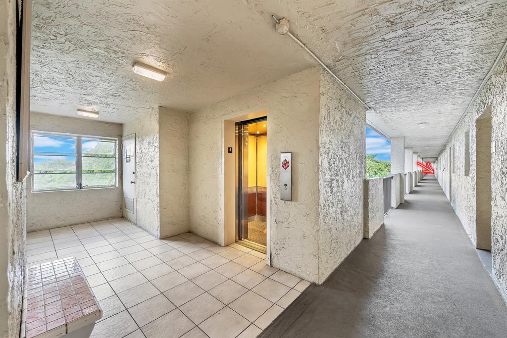 6200 Northwest 44th Street, Unit 405 Lauderhill, FL 33319 - Photo 3 of 44 a view of a hallway with windows and entryway