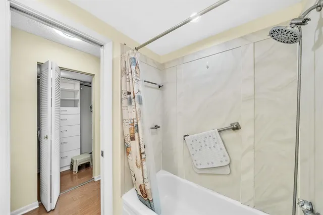 a bathroom with a bathtub and a shower