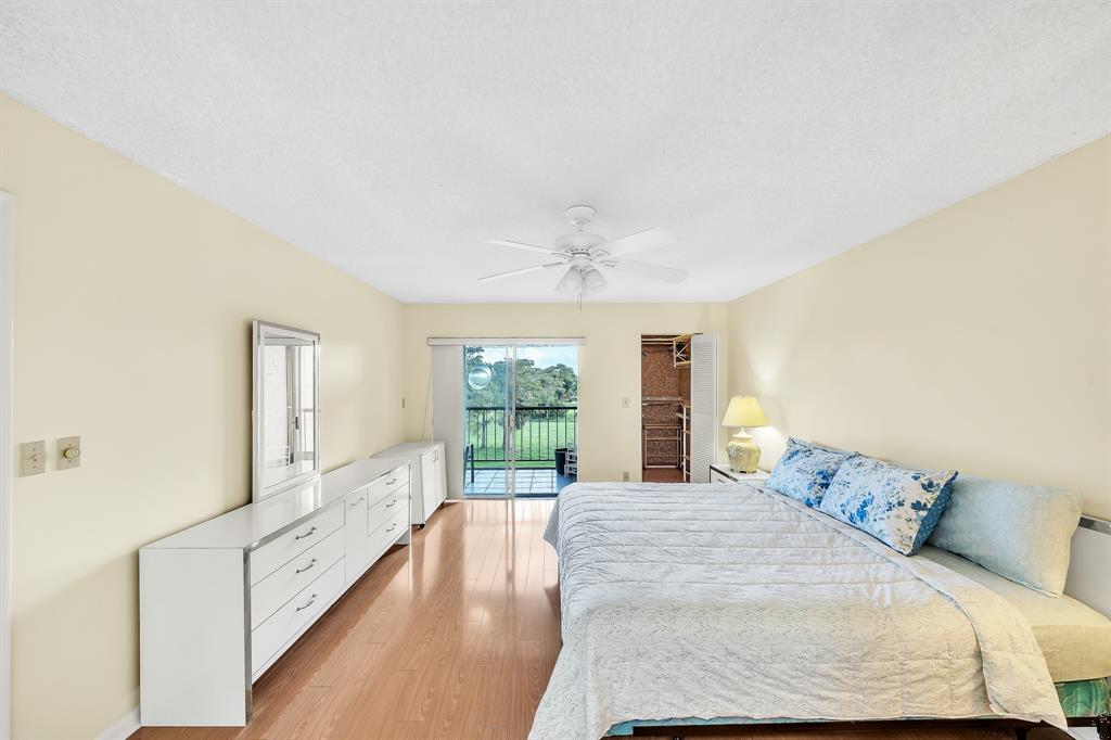 6200 Northwest 44th Street, Unit 405 Lauderhill, FL 33319 - Photo 32 of 44 a spacious bedroom with a large bed and a large window
