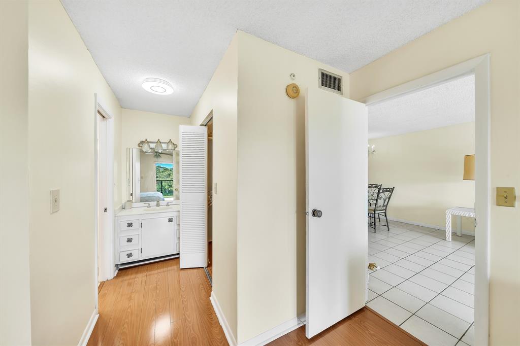 6200 Northwest 44th Street, Unit 405 Lauderhill, FL 33319 - Photo 33 of 44 a view of a hallway with closet and wooden floor