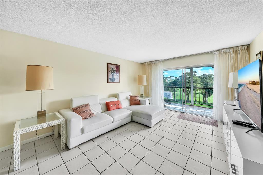 6200 Northwest 44th Street, Unit 405 Lauderhill, FL 33319 - Photo 34 of 44 a living room with furniture and a flat screen tv