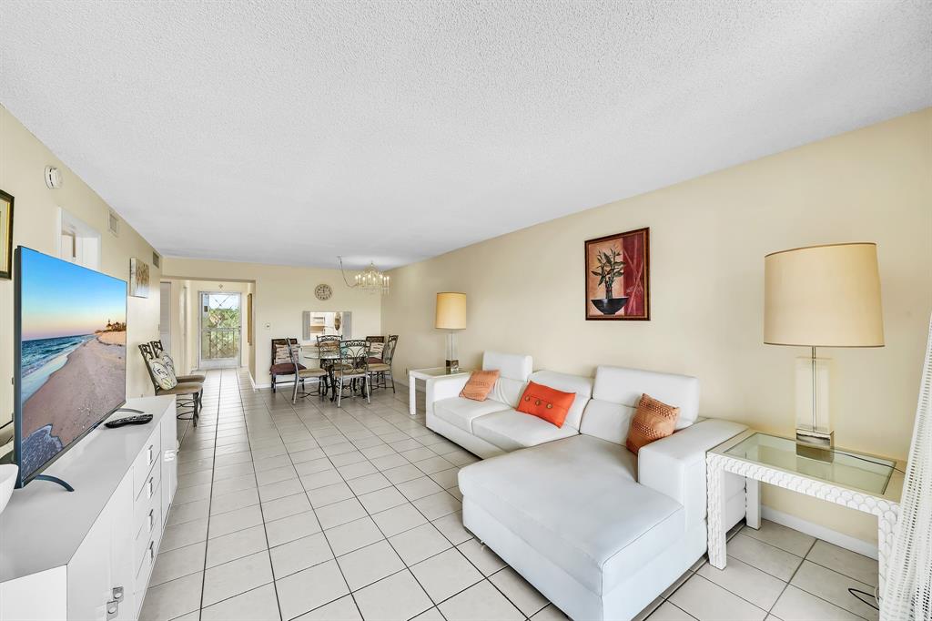 6200 Northwest 44th Street, Unit 405 Lauderhill, FL 33319 - Photo 36 of 44 a living room with furniture and a lamp