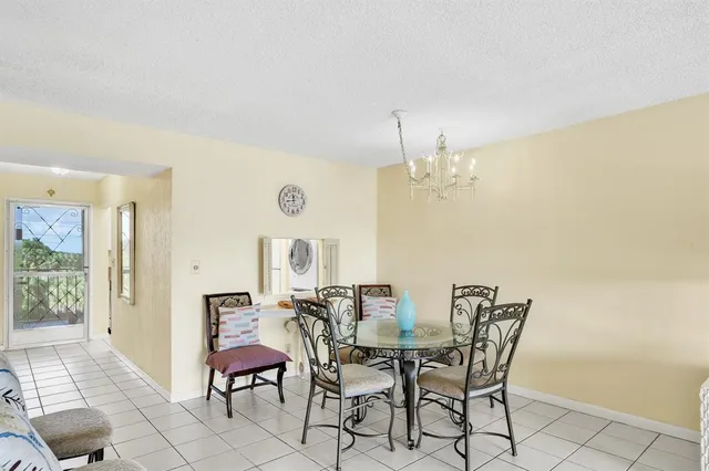 a view of a dining room with furniture and a chandelier