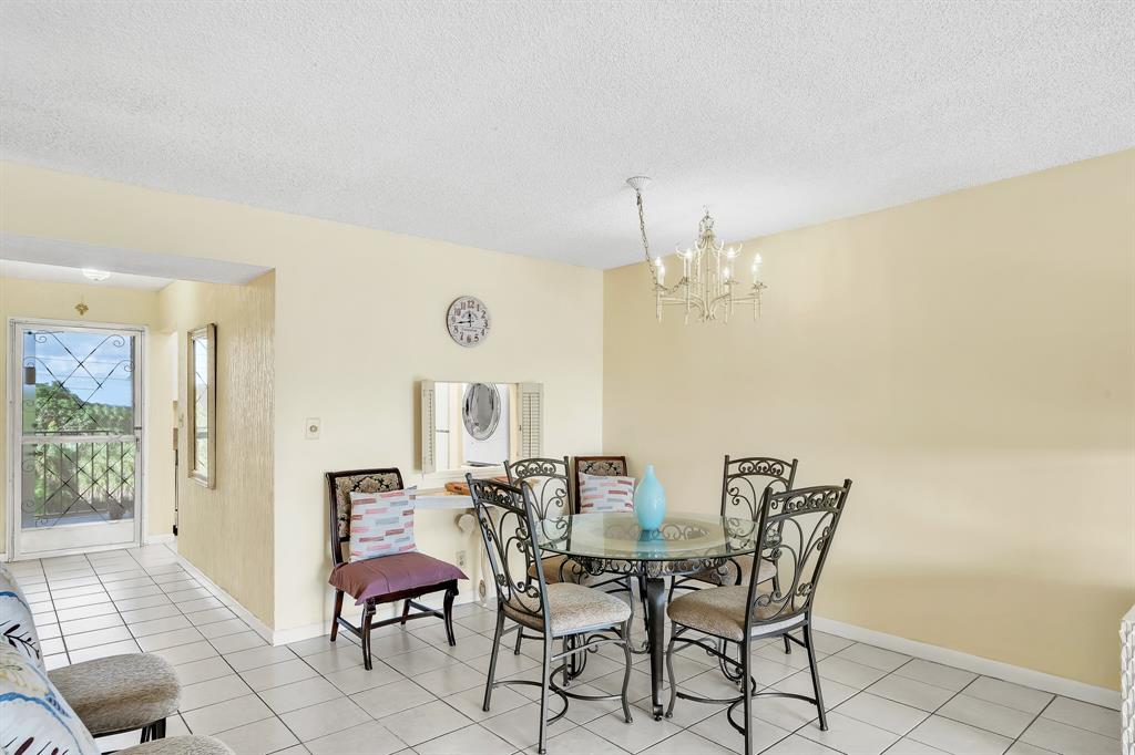 6200 Northwest 44th Street, Unit 405 Lauderhill, FL 33319 - Photo 37 of 44 a view of a dining room with furniture and a chandelier