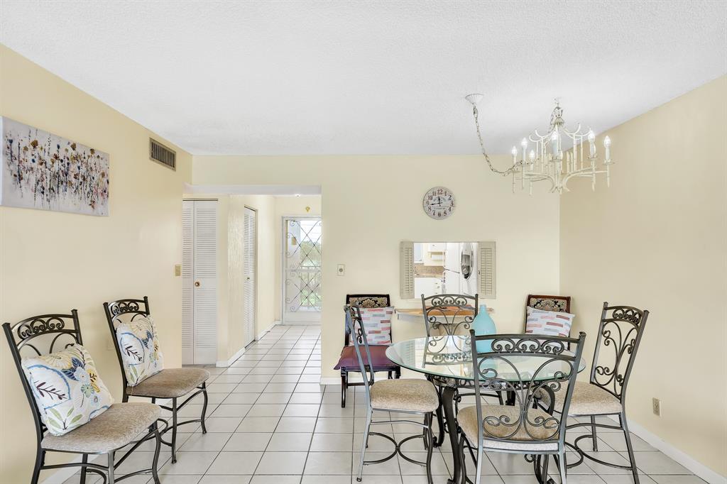 6200 Northwest 44th Street, Unit 405 Lauderhill, FL 33319 - Photo 38 of 44 a view of a dining room with furniture and chandelier