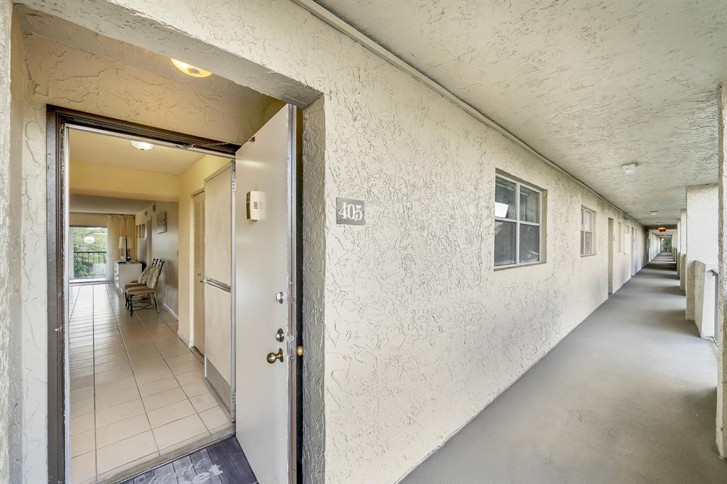 6200 Northwest 44th Street, Unit 405 Lauderhill, FL 33319 - Photo 4 of 44 a view of a hallway with a livingroom and a hall with wooden floor
