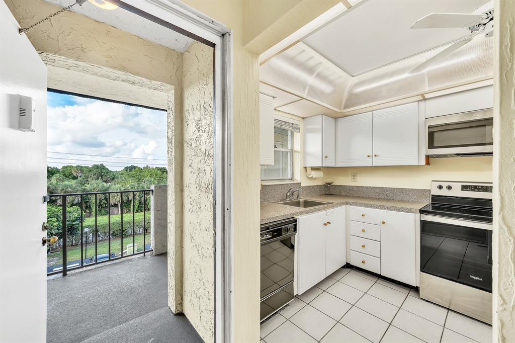 6200 Northwest 44th Street, Unit 405 Lauderhill, FL 33319 - Photo 41 of 44 a kitchen with white cabinets and white appliances