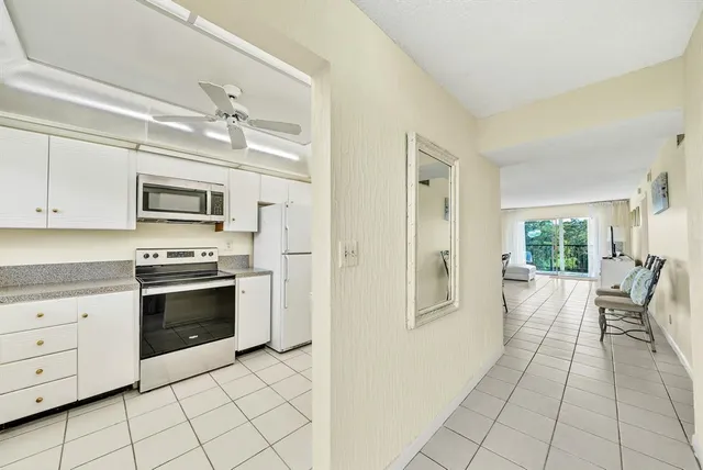 a view of a kitchen with microwave and furniture