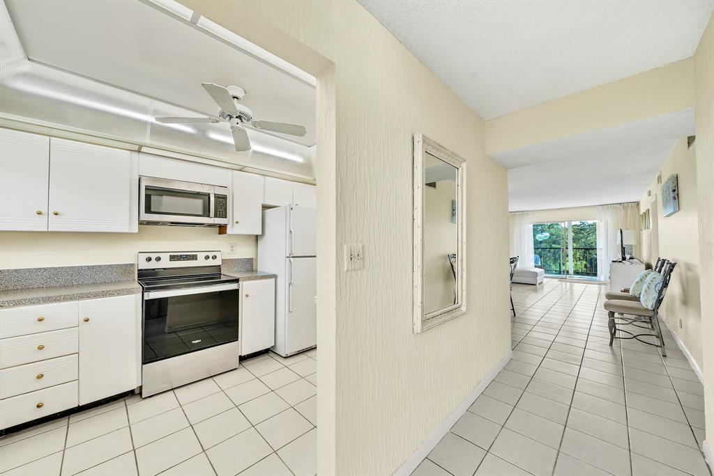 6200 Northwest 44th Street, Unit 405 Lauderhill, FL 33319 - Photo 5 of 44 a view of a kitchen with microwave and furniture