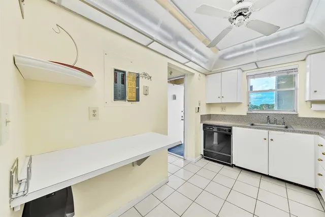 a kitchen with a sink cabinets and window