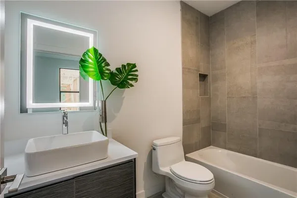 a bathroom with a sink toilet and shower