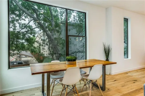a view of a dining room with furniture and wooden floor