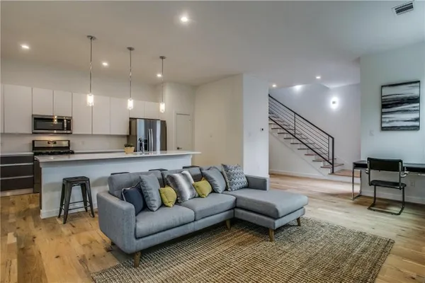 a living room with furniture and kitchen view