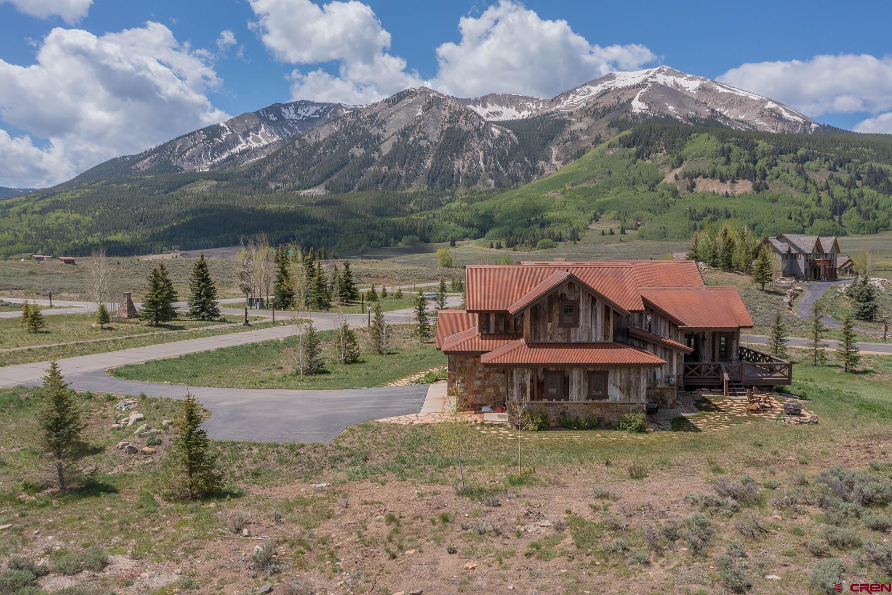 47 Fairway Lane Crested Butte, CO 81224 - Photo 19 of 32 a view of a house with a yard and a forest