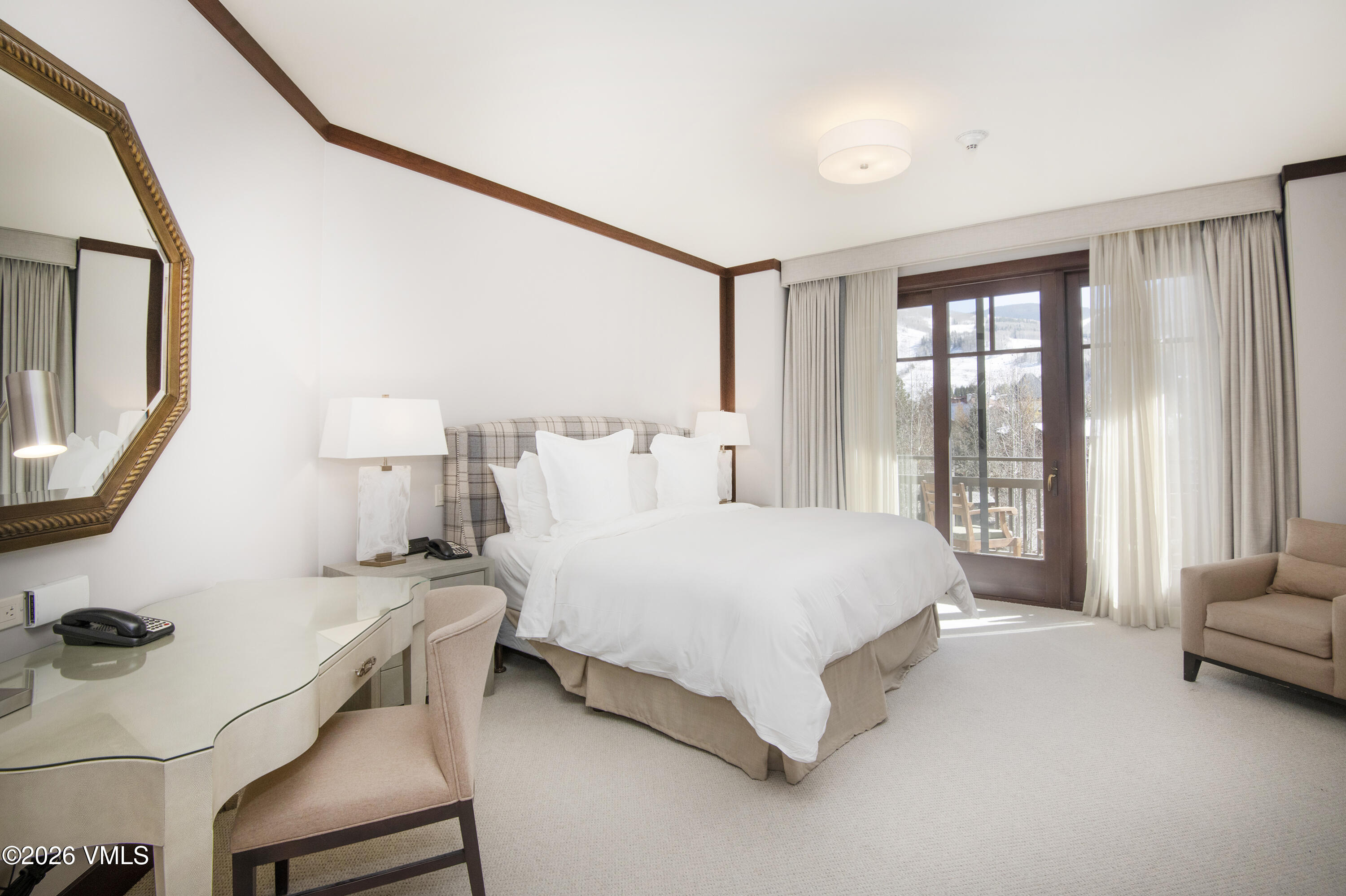 1 Vail Road, Unit 5102C Vail, CO 81657 - Photo 6 of 13 a spacious bedroom with a bed a couch and a large window