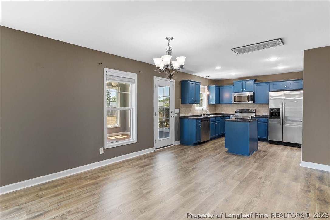 269 Declaration Drive Raeford, NC 28376 - Photo 13 of 44 a kitchen with stainless steel appliances kitchen island granite countertop a stove and a sink