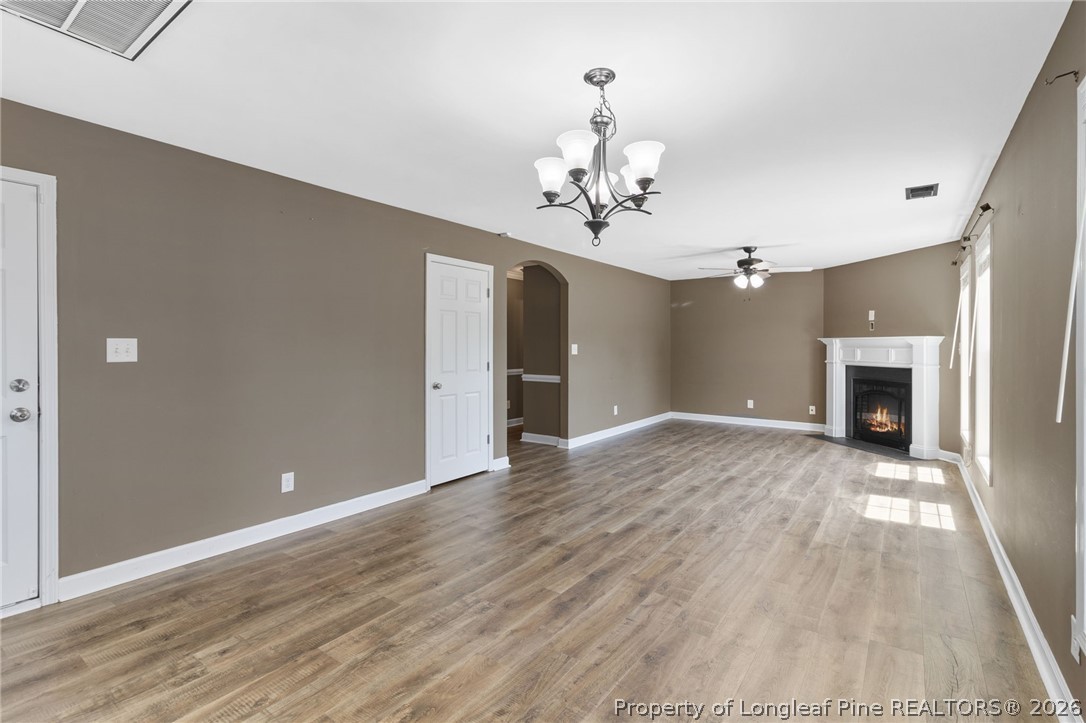 269 Declaration Drive Raeford, NC 28376 - Photo 14 of 44 a view of an empty room with wooden floor and a fireplace